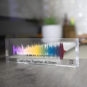 May include: A clear acrylic block displaying a colorful sound wave pattern. The sound wave transitions from purple to red, with the text "Let's Stay Together - Al Green" below the wave. A QR code is on the right side.