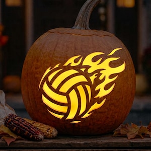 May include: A carved orange pumpkin featuring a glowing yellow cutout design of a volleyball surrounded by stylized flames. The pumpkin has a thick stem and sits on a wooden surface next to two ears of dried multicolored corn.