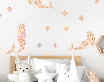 May include: A white wall with a variety of colorful mermaid and seashell decals. The decals are arranged in a whimsical pattern, creating a fun and playful atmosphere. The decals are perfect for adding a touch of magic to any child's room.