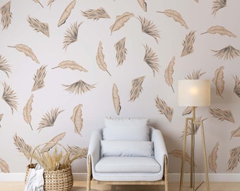 May include: A light gray armchair with a light brown wooden frame sits in front of a wall with a beige background and a pattern of brown palm leaves. A floor lamp with a white lampshade and a light brown wooden frame stands to the right of the chair. A wicker basket with dried plants sits on the floor in front of the chair.