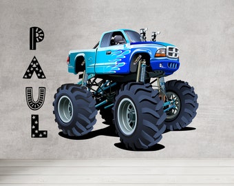 May include: A cartoon illustration of a blue monster truck with large tires and flame decals. The truck is set against a gray background with the name "PAUL" in black letters.