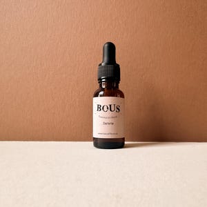 May include: A small brown glass bottle with a black dropper top. The bottle is labelled "BOUS Essential Oil Blend" and "Serene" with the website "www.bousife.co.uk".