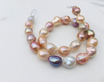 May include: A strand of baroque pearls in shades of pink, white, and lavender. The pearls are strung on a clear thread and are of varying sizes and shapes.