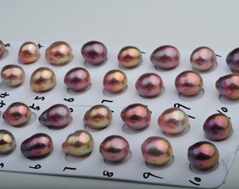 May include: A close-up of a tray of 25 iridescent pink pearls, each pearl is in a numbered slot on the tray.