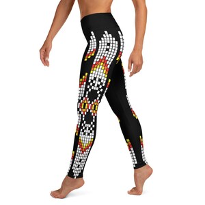 May include: Black yoga leggings with a geometric pattern in white, yellow, orange, and red. The pattern is a series of squares and rectangles.