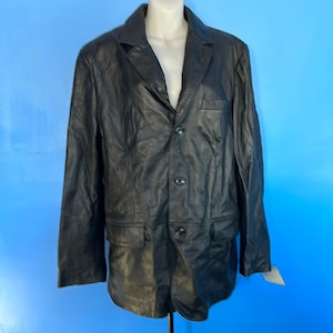 May include: A black leather blazer with a three-button closure and two front pockets.