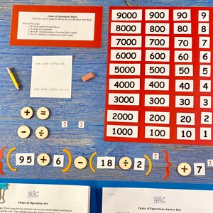 May include: A colorful educational game for learning the order of operations in math. The game includes a red and white chart with numbers from 1 to 9000, a set of colorful wooden math symbols, and a worksheet with math problems. The game is designed to help children learn the order of operations, which is a fundamental concept in mathematics.