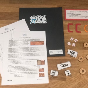 Puede incluir: Un conjunto de materiales educativos para ense&ntilde;ar el orden de las operaciones, que incluye un conjunto de n&uacute;meros de madera, una regla, una gu&iacute;a laminada y un conjunto de hojas de trabajo. Los materiales est&aacute;n etiquetados con el logotipo de ABC Crate.