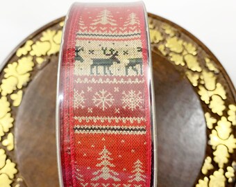 May include: A roll of red and beige Christmas ribbon with a repeating pattern of snowflakes, pine trees, and reindeer.