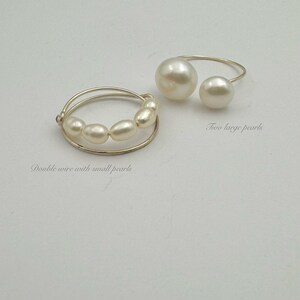 May include: Two pearl rings. One ring features two large pearls on a gold wire. The other ring has a double wire with a row of smaller pearls.
