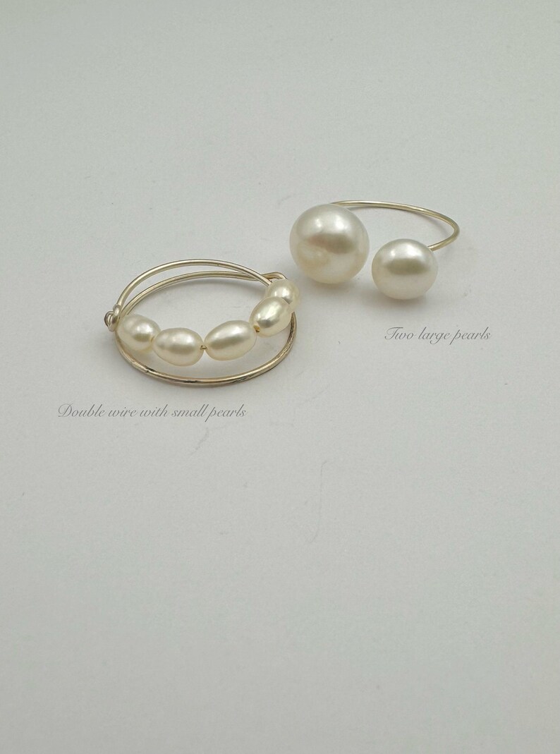 May include: Two pearl rings. One ring features two large pearls on a gold wire. The other ring has a double wire with a row of smaller pearls.