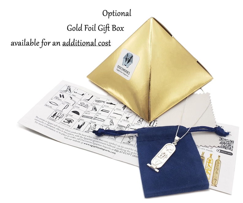 May include: A silver Ankh pendant necklace with a blue velvet pouch and a gold foil gift box. The pendant is a replica of an ancient Egyptian symbol. The box has the text "DISCOVERIES Egyptian Imports" on it. The pouch has a drawstring closure. The image also includes a card with a chart of hieroglyphs.