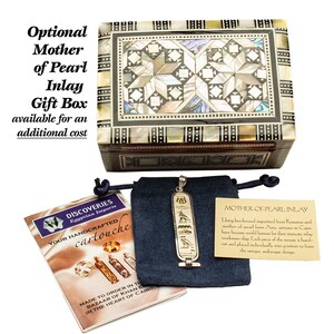May include: A wooden box with a mother-of-pearl inlay design. The box is closed and has a dark brown wood finish. The box is sitting on a white surface. The text "MOTHER-OF-PEARL INLAY" is visible on a small card in the image. The card explains that the box is made with beechwood imported from Romania and mother-of-pearl from Asia. The artisans in Cairo are known for their intricate inlay work.