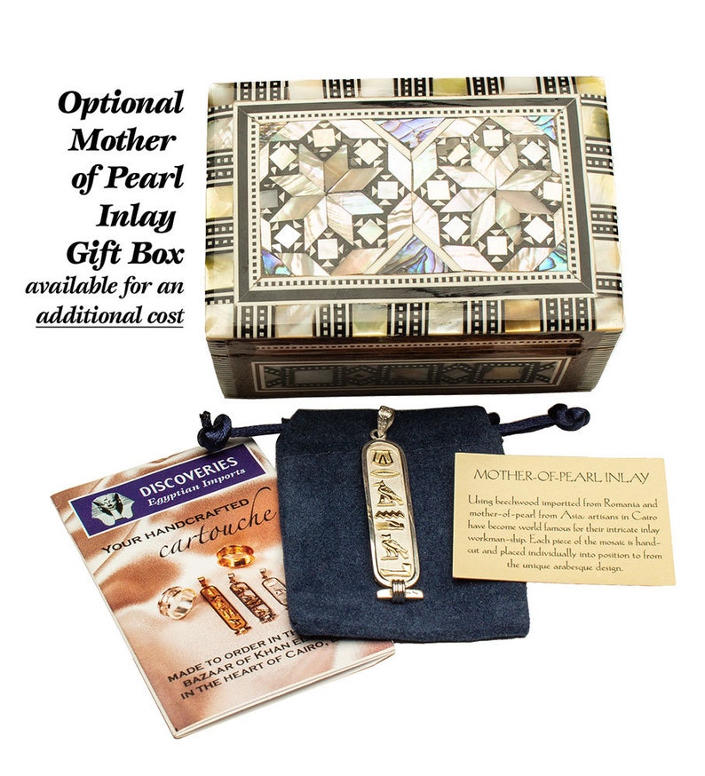 May include: A wooden box with a mother-of-pearl inlay design. The box is closed and has a dark brown wood finish. The box is sitting on a white surface. The text "MOTHER-OF-PEARL INLAY" is visible on a small card in the image. The card explains that the box is made with beechwood imported from Romania and mother-of-pearl from Asia. The artisans in Cairo are known for their intricate inlay work.