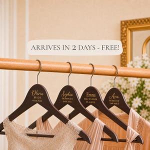 May include: Four dark brown wooden hangers with silver metal hooks, each personalized with gold text. The hangers feature names including Olivia, Sophia, Emma, and Ava, along with titles like Bride, Bridesmaid, Maid of Honor, and Mother of the Bride.