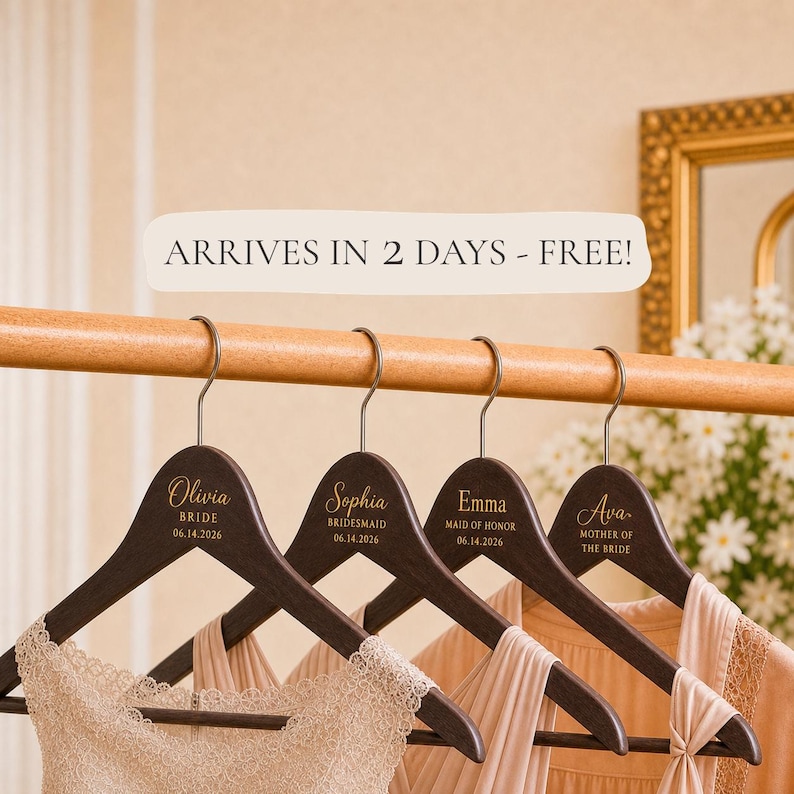 May include: Four dark brown wooden hangers with silver metal hooks, each personalized with gold text. The hangers feature names including Olivia, Sophia, Emma, and Ava, along with titles like Bride, Bridesmaid, Maid of Honor, and Mother of the Bride.