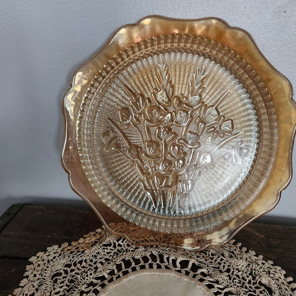 Orange/marigold carnival glass plate with iris pattern