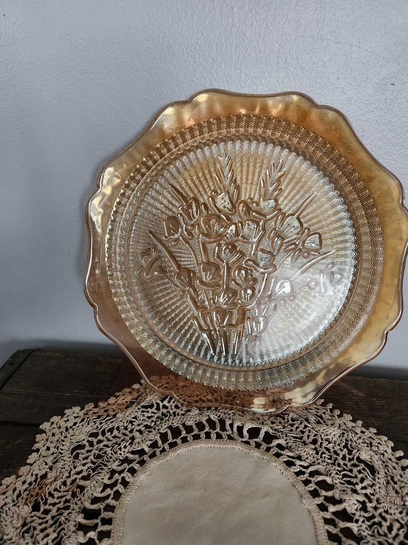 Orange/marigold carnival glass plate with iris pattern image 1