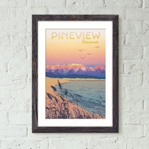 May include: Framed art print featuring a scenic landscape with the text "PINEVIEW Reservoir." The artwork depicts a lake, mountains, and birds under a colorful sunset sky. The print is in a dark wooden frame and mounted on a white brick wall.