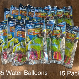 May include: Fifteen packs of water balloons, each pack containing 111 water balloons. The packaging is silver with green and yellow accents and features the text "Happy Baby Balloons" and "Fill in 60 Seconds".