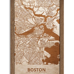May include: A wood-mounted map of Boston, Massachusetts, with the city's neighborhoods and streets outlined in brown. The map is framed in a brown wood frame. The text "BOSTON" and "UNITED OF STATE OF AMERICA" is printed below the map.