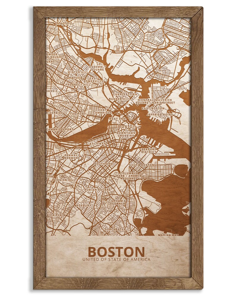 May include: A wood-mounted map of Boston, Massachusetts, with the city's neighborhoods and streets outlined in brown. The map is framed in a brown wood frame. The text "BOSTON" and "UNITED OF STATE OF AMERICA" is printed below the map.