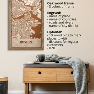 May include: A wooden map of Boston, Massachusetts, in a brown wood frame. The map is engraved with the city's streets, rivers, and landmarks. The frame is available in three colors. The map can be personalized with the name of a place, countries, roads, rivers, and city districts. The map can also be customized with 10 wooden pins to mark places to visit. The map is available for regular customers and businesses.