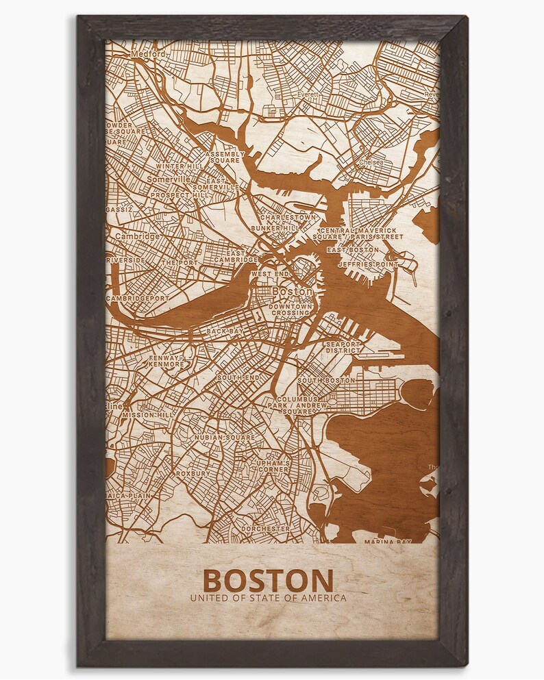 May include: A brown and white map of Boston, Massachusetts, with the city's neighborhoods and major streets labeled. The map is framed in a dark brown wood frame. The text "Boston" and "United States of America" is printed below the map.