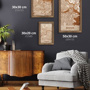 May include: Three framed maps of Boston, London, and a city in the United States. The maps are printed on a cream-colored background with brown lines. The frames are made of wood and have a brown finish. The maps are displayed on a gray wall. The Boston map is 20 inches by 12 inches, the London map is 12 inches by 8 inches, and the other map is 12 inches by 12 inches.