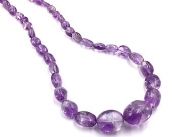 May include: A strand of purple amethyst gemstone beads, each bead is oval shaped and has a smooth, polished finish.