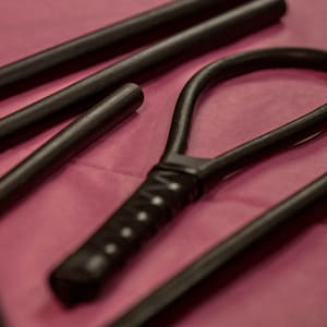 Black rubber coated rattan loop for "OTK" punishments