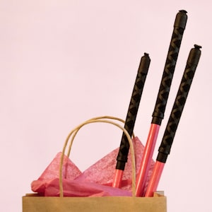 Pink rattan cane coated in pink rubber for punishments