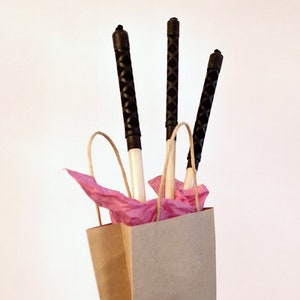 Rattan cane coated in transparent rubber for punishments