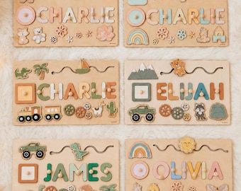 May include: Six rectangular wooden name puzzles featuring cut-out letters for the names CHARLIE, ELIJAH, JAMES, and OLIVIA. Each board includes colorful wooden shapes like animals, vehicles, rainbows, and flowers, with wavy tracks for sliding pieces.