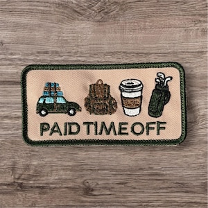 May include: A rectangular embroidered patch with a tan background and a dark green border. It features icons of a car with luggage, a backpack, a coffee cup, and a golf bag. The text PAID TIME OFF is embroidered in dark green capital letters.