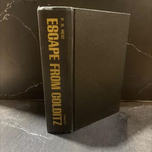May include: A hardcover book titled "ESCAPE FROM GOLDITZ" by P.R. Reid. The book's spine is black with gold lettering. The book is standing upright, with the title and author's name clearly visible.