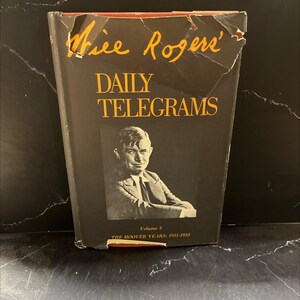 May include: A vintage book titled "Will Rogers' Daily Telegrams" with a portrait of a man on the cover. The book is black with gold lettering and shows signs of wear. Volume 3, The Hoover Years: 1931-1933.
