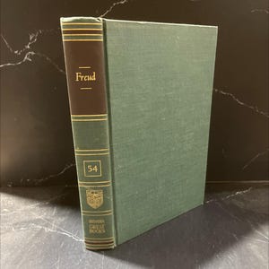 May include: A hardcover book titled "Freud" from the Britannica Great Books series. The spine is dark brown with gold lettering and accents, and the book's cover is green. The number "54" is visible on the spine.