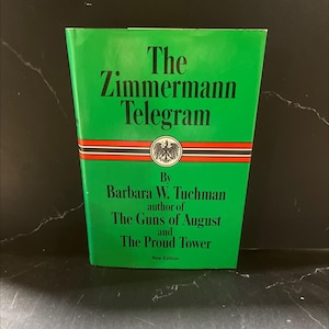 May include: A hardcover book titled "The Zimmermann Telegram" by Barbara W. Tuchman. The book has a bright green cover with black and red stripes and text. The author is also of "The Guns of August" and "The Proud Tower".