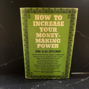 May include: A vintage book titled "How to Increase Your Money-Making Power" with a green cover and white text. The book's cover features dollar signs and a list of topics. The book is on a black surface.