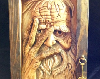 Wood carved aged man trapped in wooden picture frame, relief wood sculpture