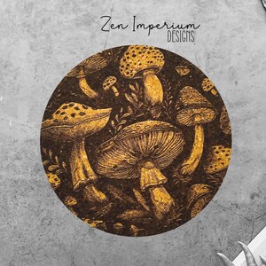May include: A round coaster with a dark brown background and a gold design of mushrooms. The coaster features a variety of mushrooms with different shapes and sizes. The text "Zen Imperium Designs" is printed in white at the top of the coaster.
