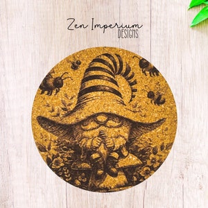 May include: A round cork coaster with a whimsical illustration of a gnome wearing a striped hat and holding a flower. The gnome is surrounded by bees and flowers. The coaster has the text "Zen Imperium Designs" printed on it.