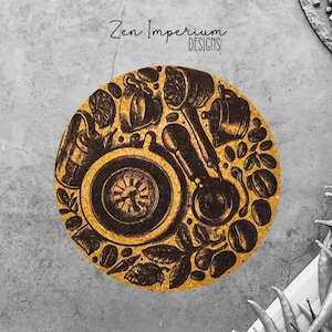 May include: A round, cork coaster with a coffee-themed design. The coaster features illustrations of coffee beans, a coffee maker, and other coffee-related items. The words "Zen Imperium DESIGNS" are at the top. The coaster is on a gray surface.