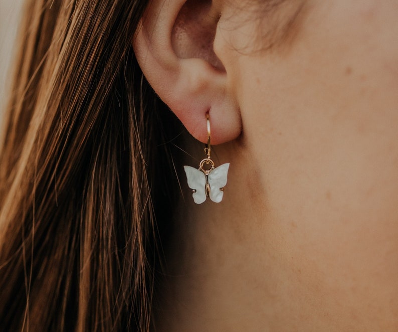 Gold hoops with white butterfly charms