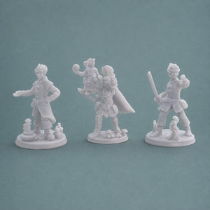 May include: Three unpainted light gray resin tabletop gaming miniatures standing on circular bases. The left figure gestures with one hand near potion bottles. The center figure holds a small child and a sphere. The right figure holds a sword.