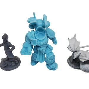 May include: Three miniature figurines, a blue armored warrior, a gray winged creature, and a gray figure with a long coat, all standing on circular bases.