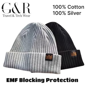 May include: Two ribbed knit beanies, one gray and one black, with a small brown label. The text on the image reads "G&R Travel & Tech Wear", "100% Cotton 100% Silver", and "EMF Blocking Protection".