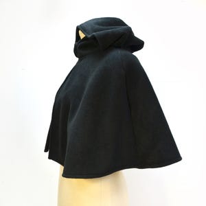 Side view of black fleece cape shown on a mannequin