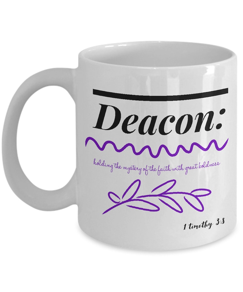 May include: White ceramic coffee mug with a black line and the word "Deacon" in black text. The text "holding the mystery of the faith with great boldness" is written in a purple font below the word "Deacon". A purple stylized branch is below the text. The text "1 timothy 3:8" is written in black at the bottom of the mug.